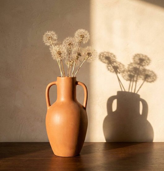 Terracotta vessels with dried flowers